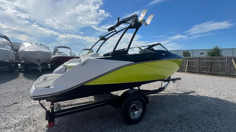 Slide: The Image of 2014 Scarab 195 HO Impulse boat on trailer, vibrant yellow and black design. - 20