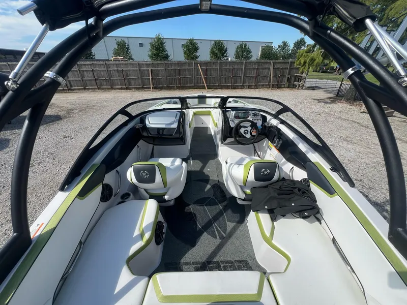 Slide: The Image of 2014 Scarab 195 HO Impulse boat interior with modern seating and steering wheel. - 24