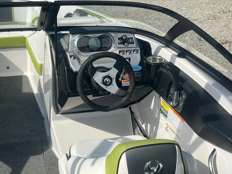 Slide: The Image of 2014 Scarab 195 HO Impulse boat interior with steering wheel and dashboard controls. - 25