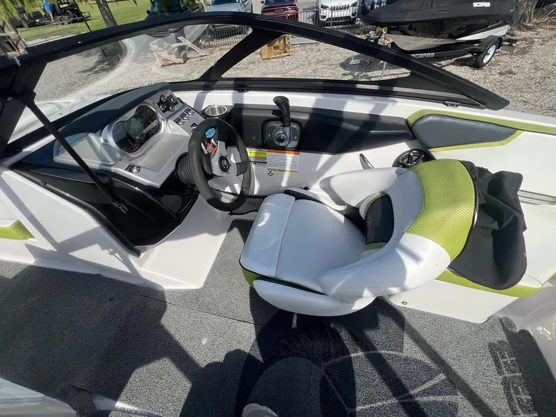 Slide: The Image of 2014 Scarab 195 HO Impulse boat interior with steering wheel and seating. - 5