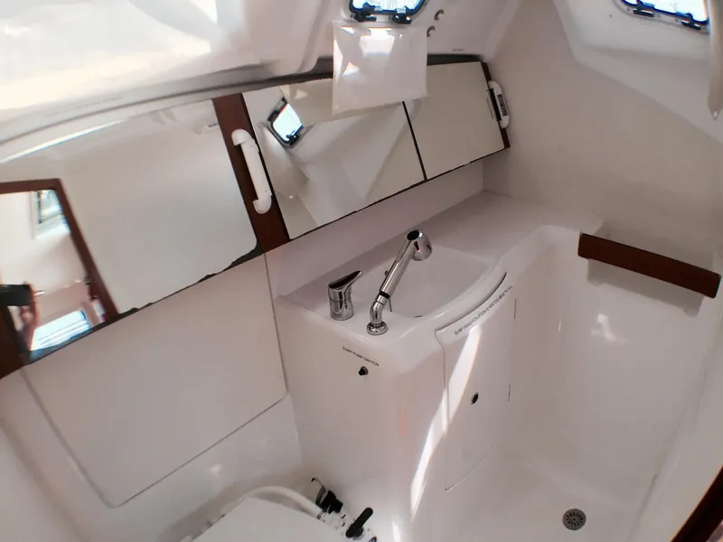 Slide: The Image of Modern bathroom in 2014 Beneteau Oceanis 34 sailboat with sink and storage cabinets. - 11