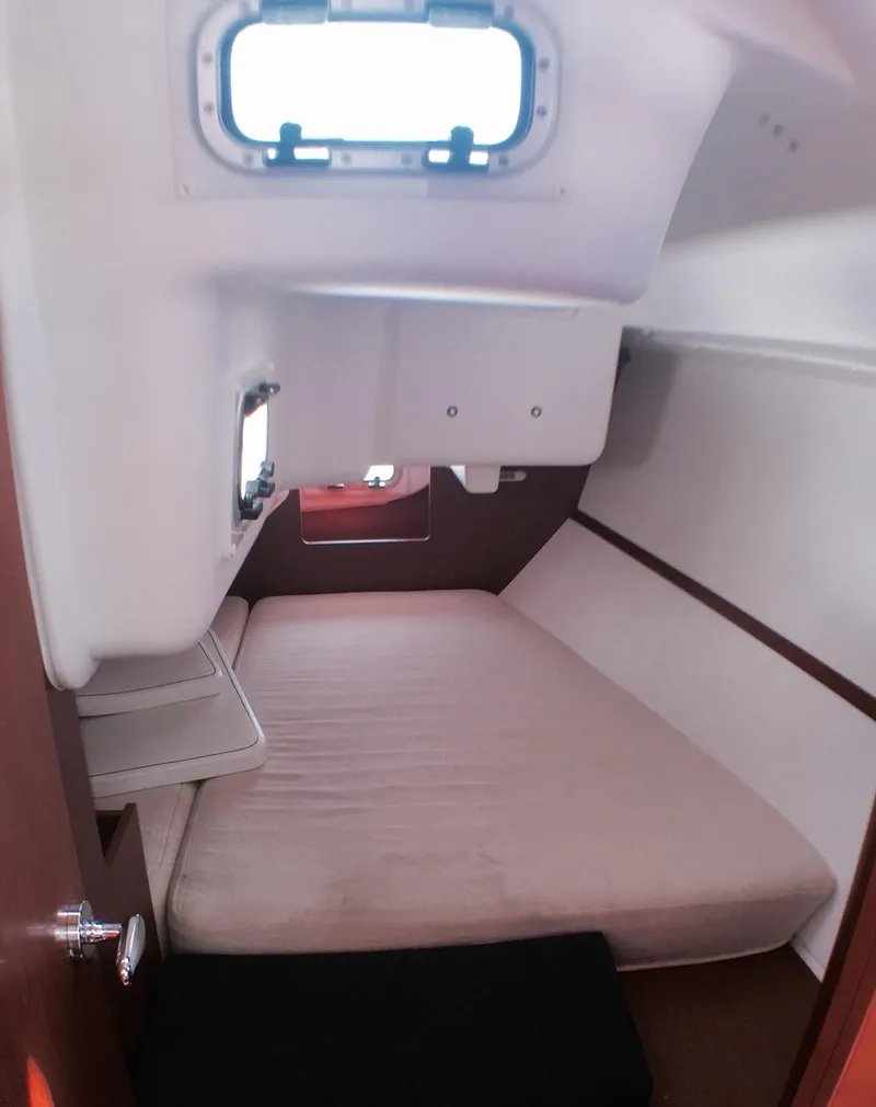 Slide: The Image of Cozy cabin interior of 2014 Beneteau Oceanis 34 sailboat with a comfortable bed. - 15
