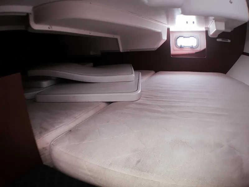 Slide: The Image of Beneteau Oceanis 34 2014 interior cabin with bed and cushions. - 16