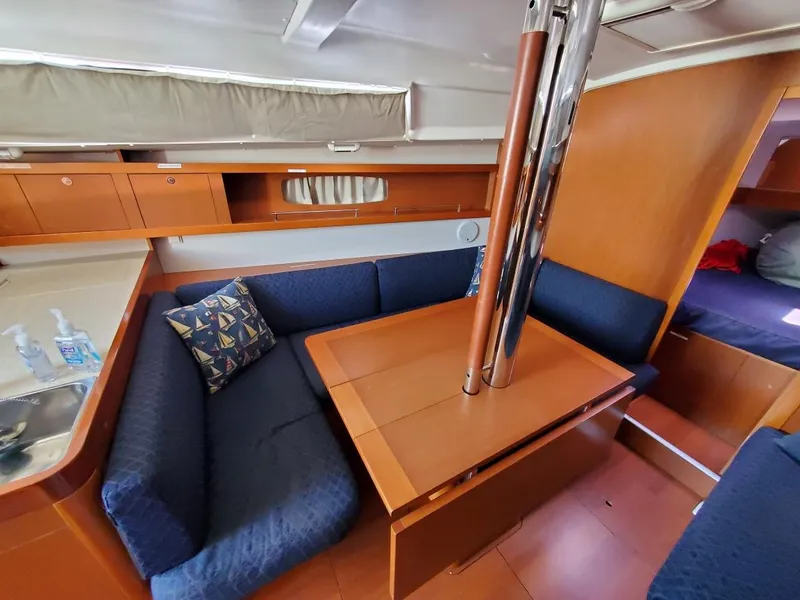 Slide: The Image of Interior of 2014 Beneteau Oceanis 34 sailboat with cozy seating and dining area. - 8
