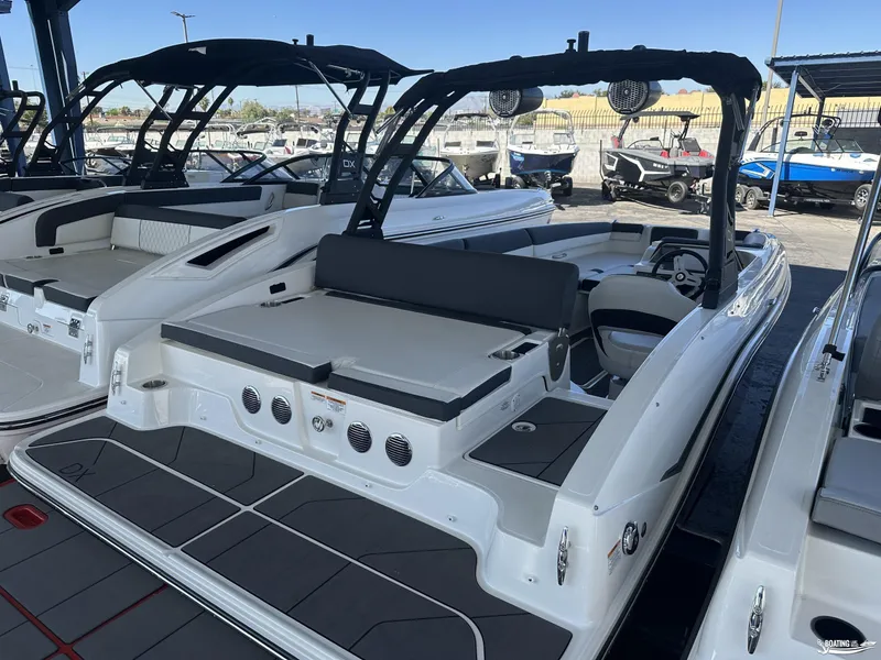 Slide: The Image of 2023 Bayliner DX2050 boat with sleek design and spacious seating in a showroom. - 4