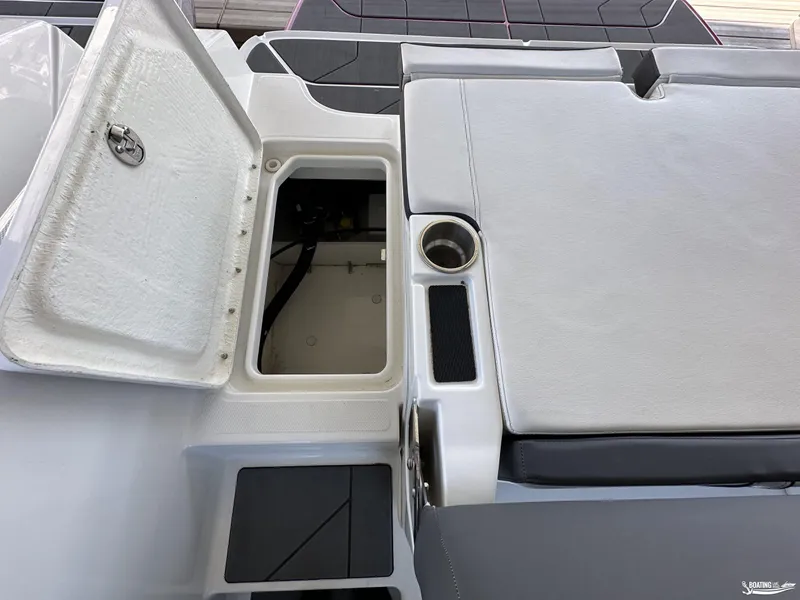Slide: The Image of 2023 Bayliner DX2050 boat storage compartment and seating area. - 5