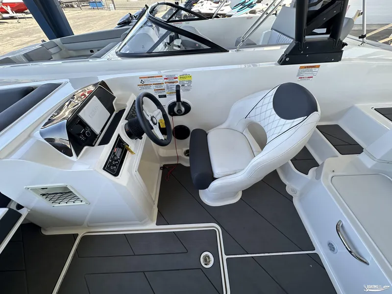 Slide: The Image of 2023 Bayliner DX2050 boat interior with steering wheel and seating. - 8