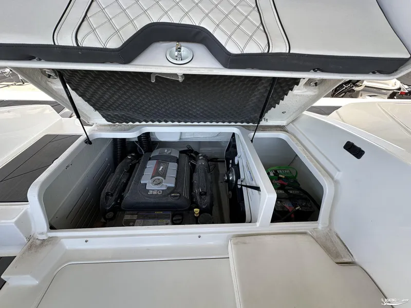 Slide: The Image of 2023 Bayliner DX2050 engine compartment with open hatch, showcasing engine and battery. - 9