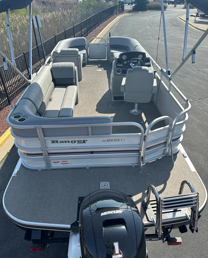 Slide: The Image of 2023 Ranger Reata 220C pontoon boat with spacious seating and Mercury engine. - 2