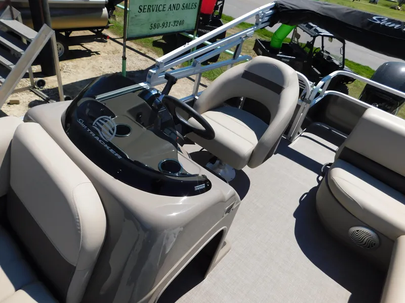 Slide: The Image of 2023 Sun Tracker Party Barge 18 DLX interior with helm and seating. - 4