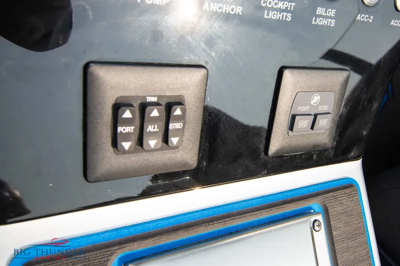 Slide: The Image of Control panel of 2025 Fountain 34 Thunder Cat boat with trim and port buttons. - 44