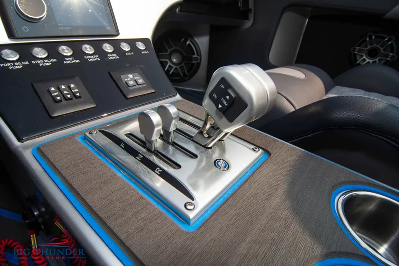 Slide: The Image of Center console of 2025 Fountain 34 Thunder Cat with gear shift and control panel. - 45