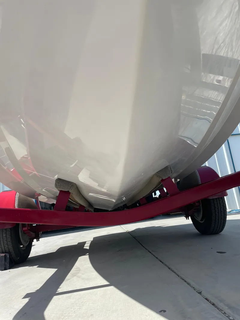 Slide: The Image of 1996 Four Winns 190 Horizon DLX boat on red trailer, viewed from below. - 10