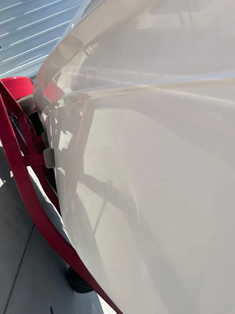 Slide: The Image of 1996 Four Winns 190 HORIZON DLX boat side view with red trailer. - 12