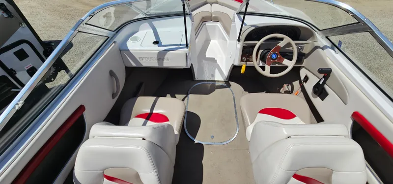 Slide: The Image of 1996 Four Winns 190 Horizon DLX boat interior with white and red seating. - 13