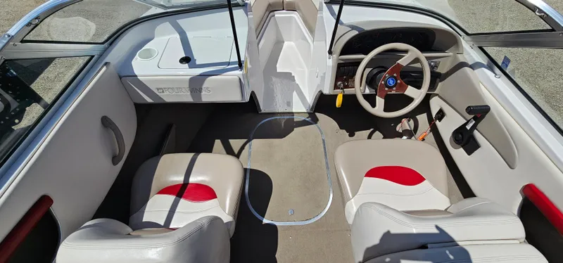 Slide: The Image of 1996 Four Winns 190 Horizon DLX boat interior with beige and red seating. - 14