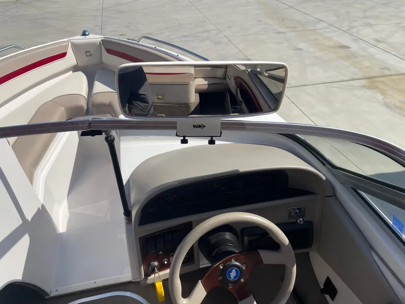 Slide: The Image of 1996 Four Winns 190 HORIZON DLX boat interior with steering wheel and seating area. - 23