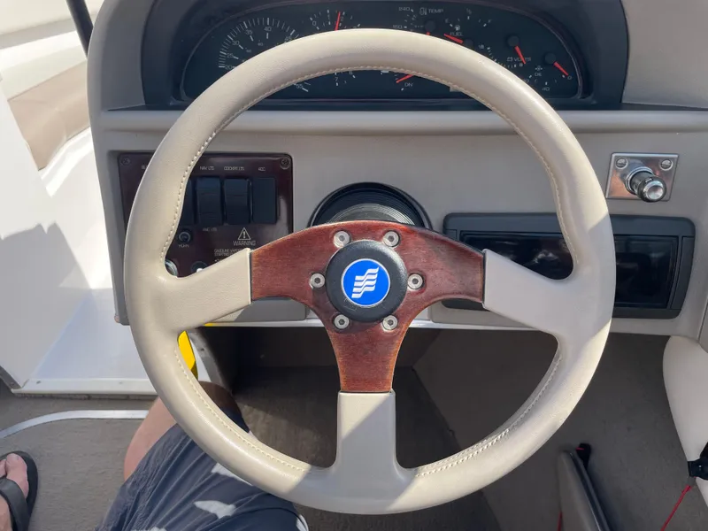Slide: The Image of Steering wheel of a 1996 Four Winns 190 Horizon DLX boat, featuring classic design elements. - 24