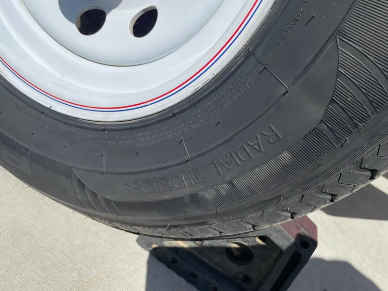 Slide: The Image of Close-up of a radial tubeless tire on a 1996 Four Winns 190 Horizon DLX boat trailer. - 38