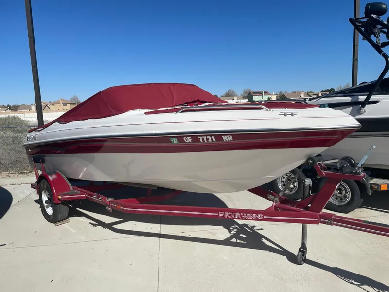 Slide: The Image of 1996 Four Winns 190 Horizon DLX boat with red cover on trailer. - 7