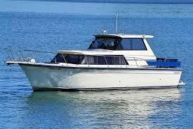 Slide: The Image of 1990 Marinette 28 Sport Fish Fly Bridge on calm water. - 12