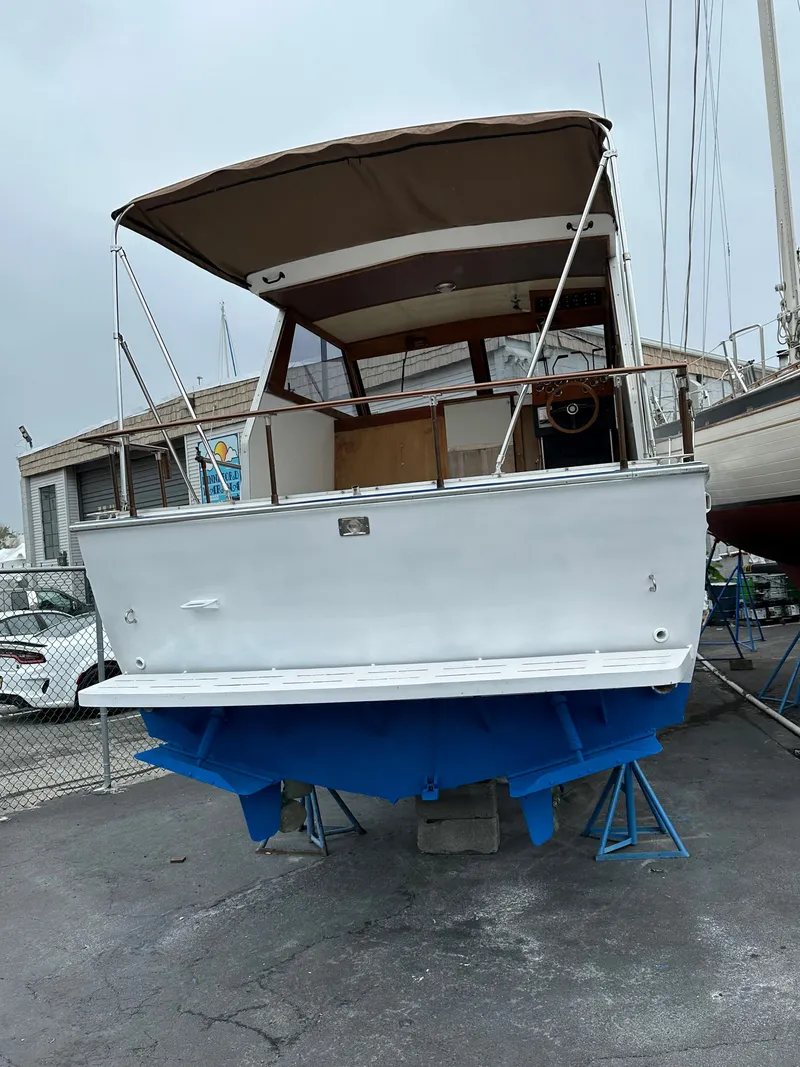 Slide: The Image of 1990 Marinette 28 Sport Fish Fly Bridge on stands in harbor. - 8