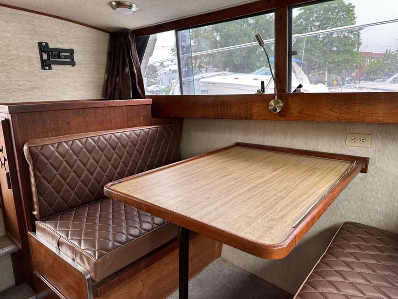 Slide: The Image of Interior of 1990 Marinette 28 Sport Fish Fly Bridge with seating area. - 9