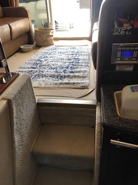 Slide: The Image of Interior of 2007 Sea Ray 36 Sedan Bridge yacht, showing steps, seating, and a rug. - 11
