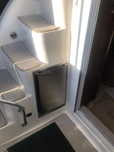 Slide: The Image of 2007 Sea Ray 36 Sedan Bridge interior stairs and mini fridge. - 16