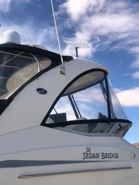 Slide: The Image of 2007 Sea Ray 36 Sedan Bridge boat under a clear blue sky. - 24
