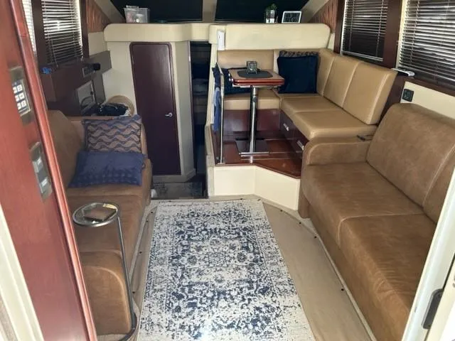 Slide: The Image of Interior of 2007 Sea Ray 36 Sedan Bridge with brown seating and a patterned rug. - 25