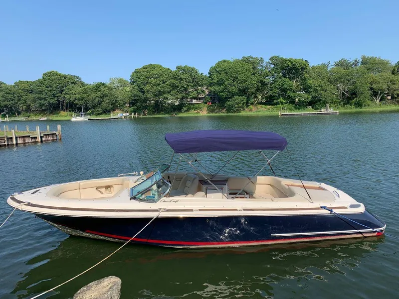 Slide: The Image of 2006 Chris-Craft Launch 25 boat with canopy on a calm lake. - 4