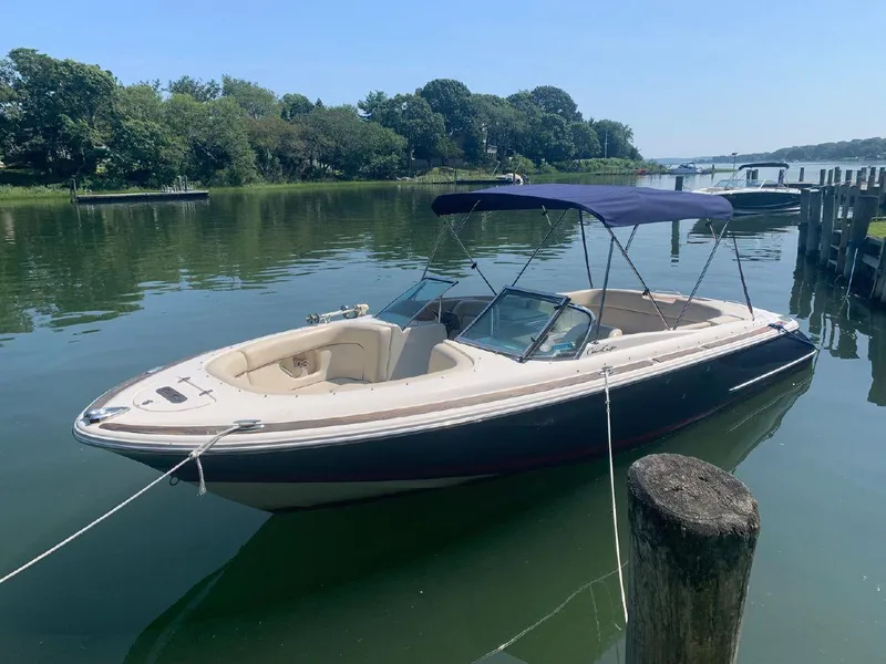 Slide: The Image of 2006 Chris-Craft Launch 25 boat docked on a serene lake. - 7