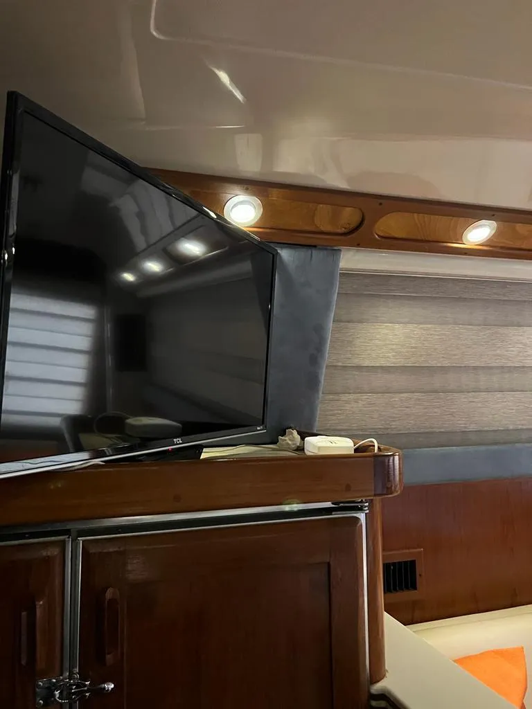 Slide: The Image of Interior of 1994 Luhrs 380 Tournament boat with TV and wooden cabinetry. - 10