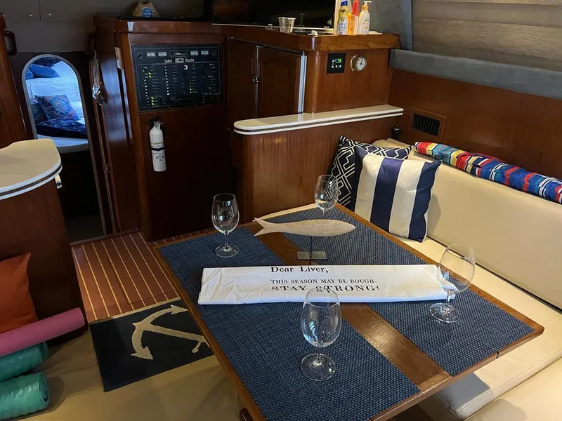 Slide: The Image of Interior of 1994 Luhrs 380 Tournament yacht with dining area and nautical decor. - 13