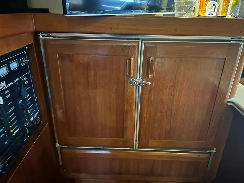 Slide: The Image of 1994 Luhrs 380 Tournament wooden cabinet interior with control panel. - 14