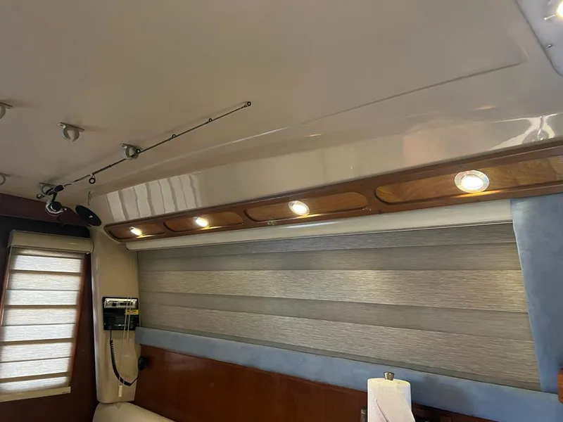 Slide: The Image of 1994 Luhrs 380 Tournament interior with wood paneling, lighting, and window blinds. - 15