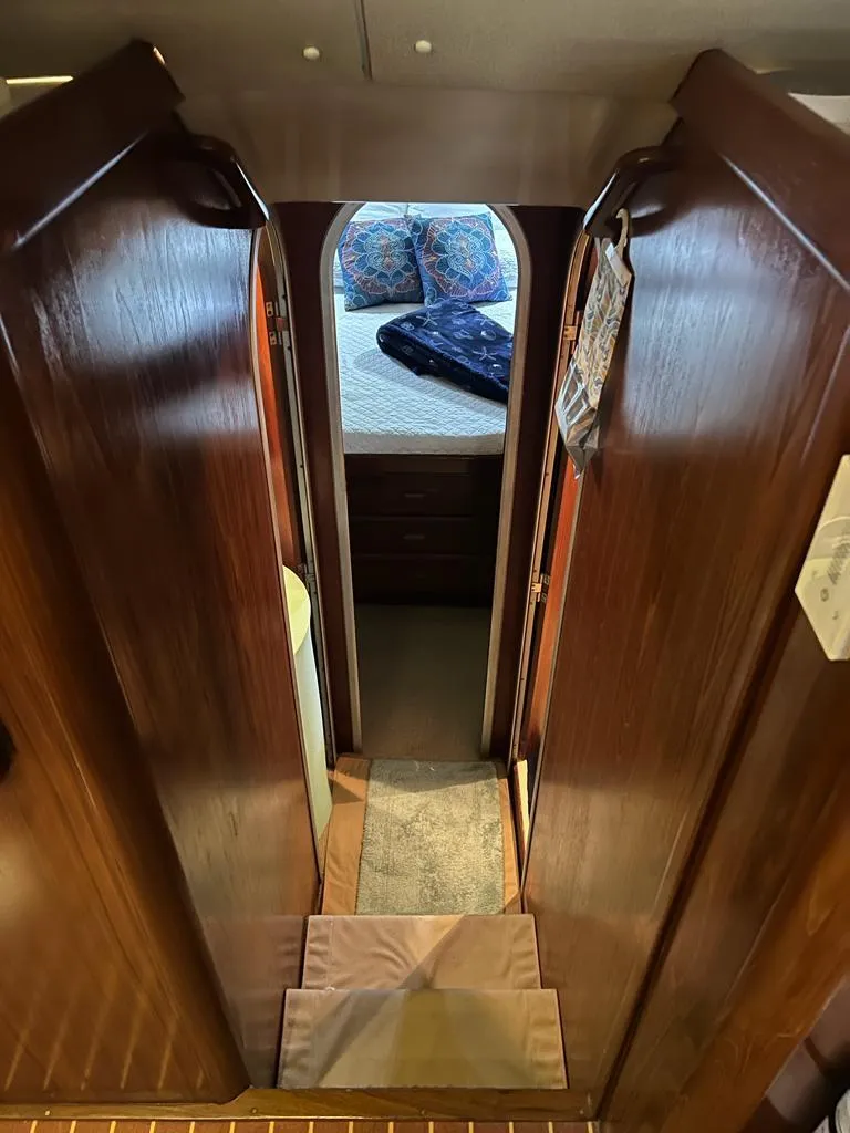 Slide: The Image of 1994 Luhrs 380 Tournament interior with wooden cabinetry and cozy bedroom view. - 16