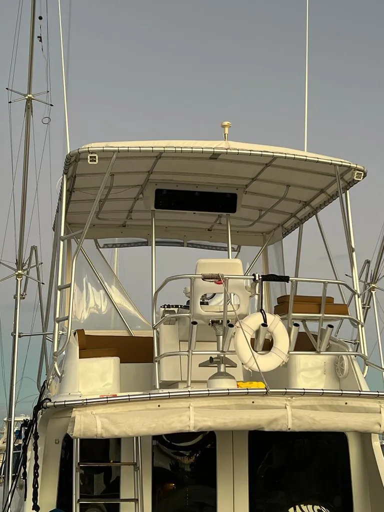 Slide: The Image of 1994 Luhrs 380 Tournament boat with upper deck and fishing equipment. - 2