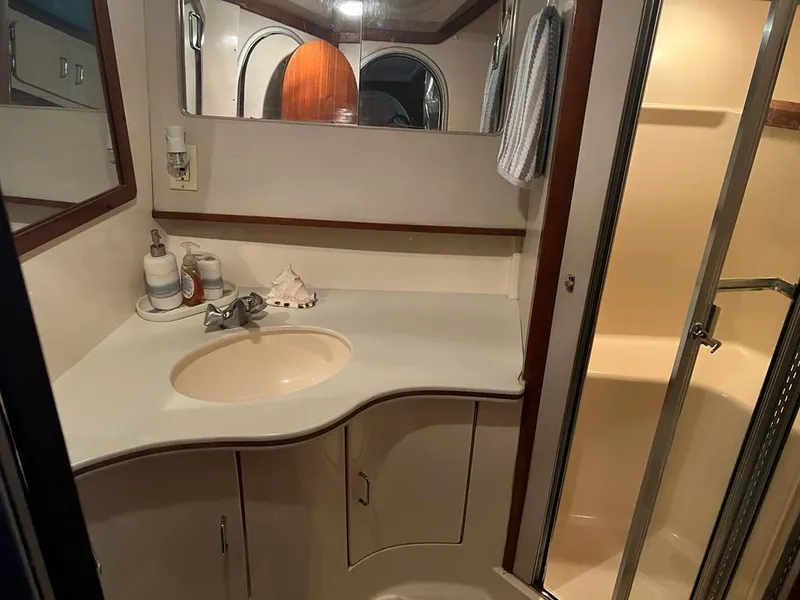 Slide: The Image of 1994 Luhrs 380 Tournament yacht bathroom with sink, mirror, and shower. - 20