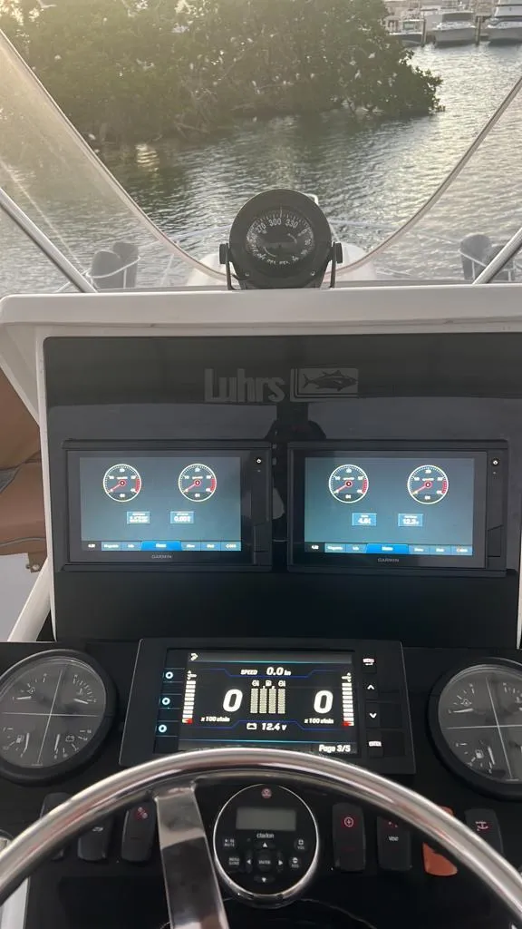 Slide: The Image of Helm of 1994 Luhrs 380 Tournament boat with modern navigation displays. - 21