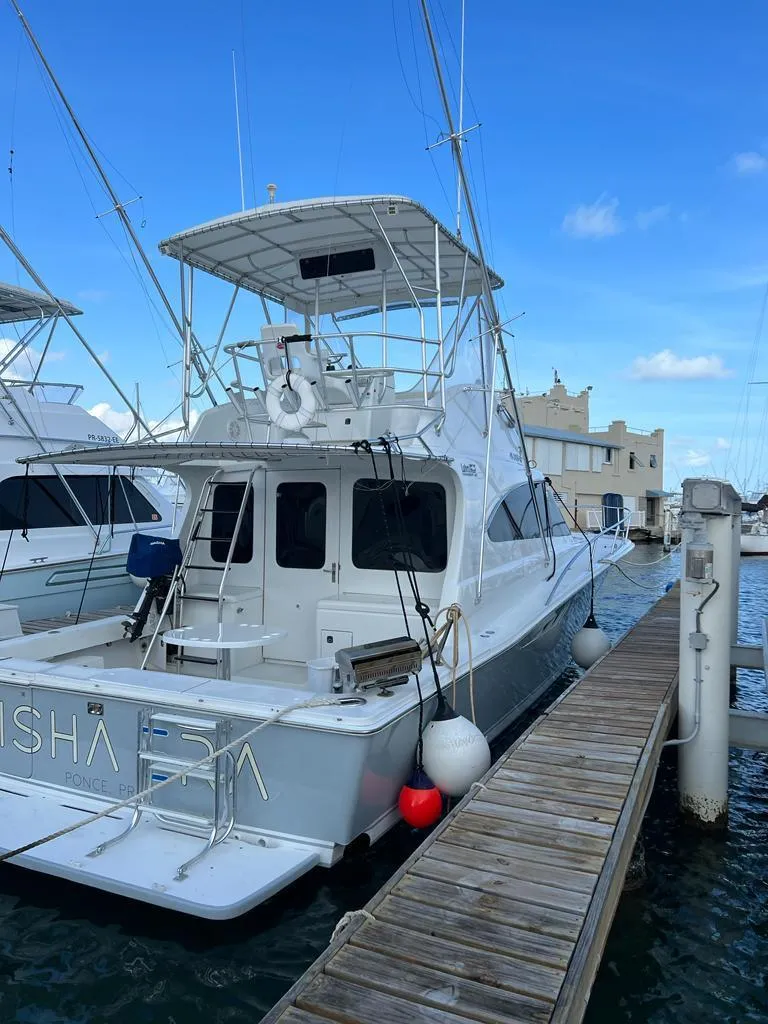 Slide: The Image of 1994 Luhrs 380 Tournament yacht docked at marina, clear blue sky. - 3