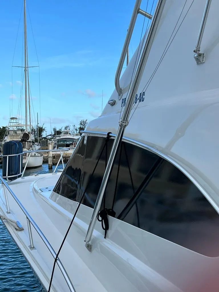 Slide: The Image of 1994 Luhrs 380 Tournament boat docked at marina, side view with clear blue sky. - 5