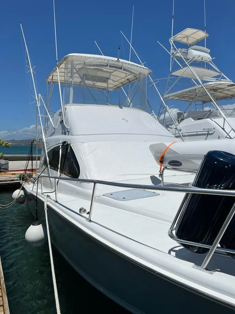 Slide: The Image of 1994 Luhrs 380 Tournament boat docked under clear blue sky. - 6
