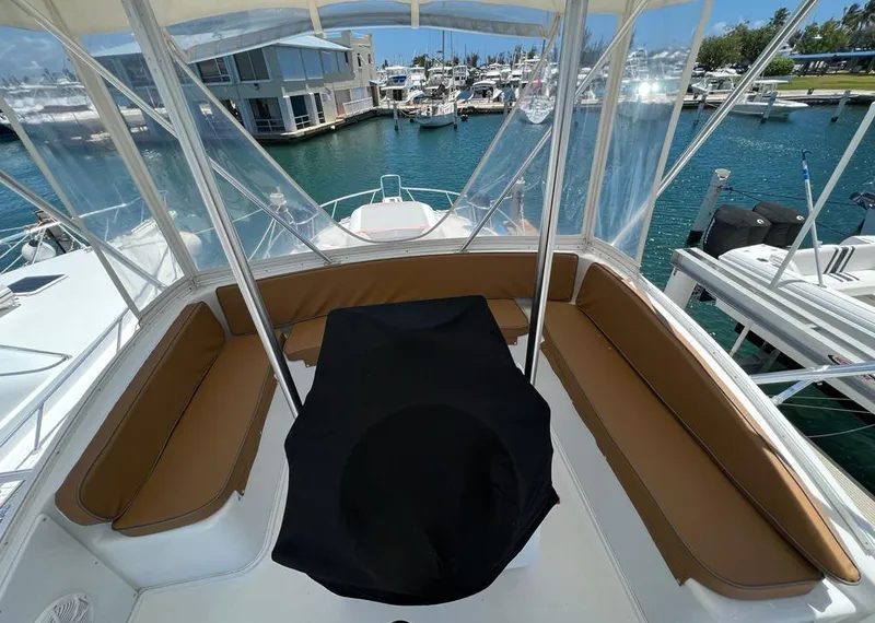 Slide: The Image of 1994 Luhrs 380 Tournament boat cockpit with seating, docked at marina. - 7