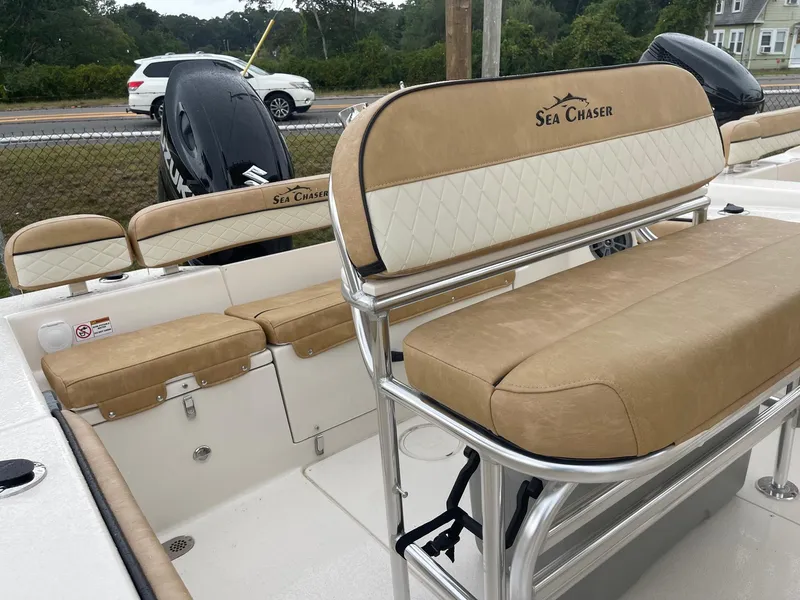 Slide: The Image of 2023 Sea Chaser 22 HFC boat interior with tan and white seating. - 2