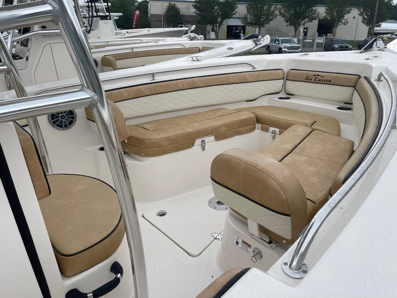 Slide: The Image of 2023 Sea Chaser 22 HFC boat with tan and white cushioned seating. - 3