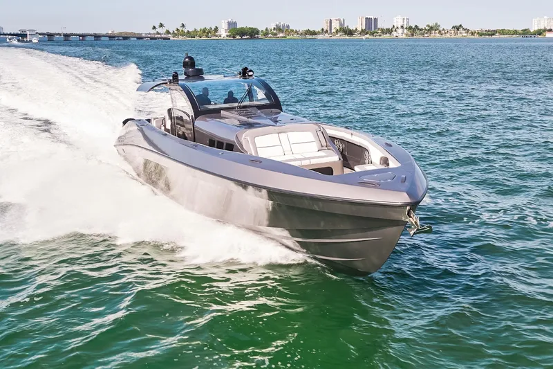 Slide: The Image of 2019 Midnight Express 60' Pied-A-Mer luxury yacht cruising on open water. - 3