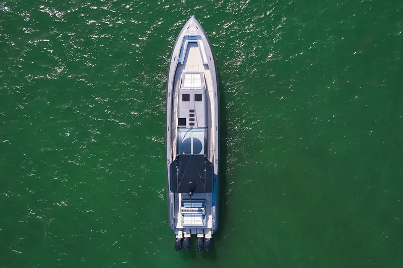 Slide: The Image of Aerial view of 2019 Midnight Express 60' Pied-A-Mer yacht on green water. - 4