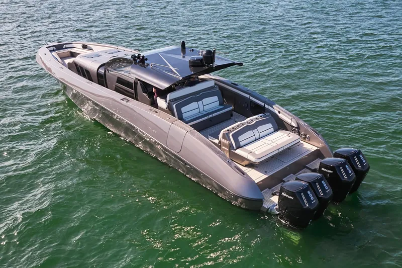 Slide: The Image of 2019 Midnight Express 60' Pied-A-Mer luxury boat on water with four outboard engines. - 8